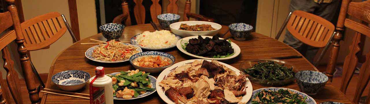 thanksgiving dinner with sliced turkey and chinese food side dishes and chopsticks