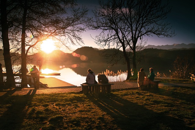 people enjoying sunset by lake