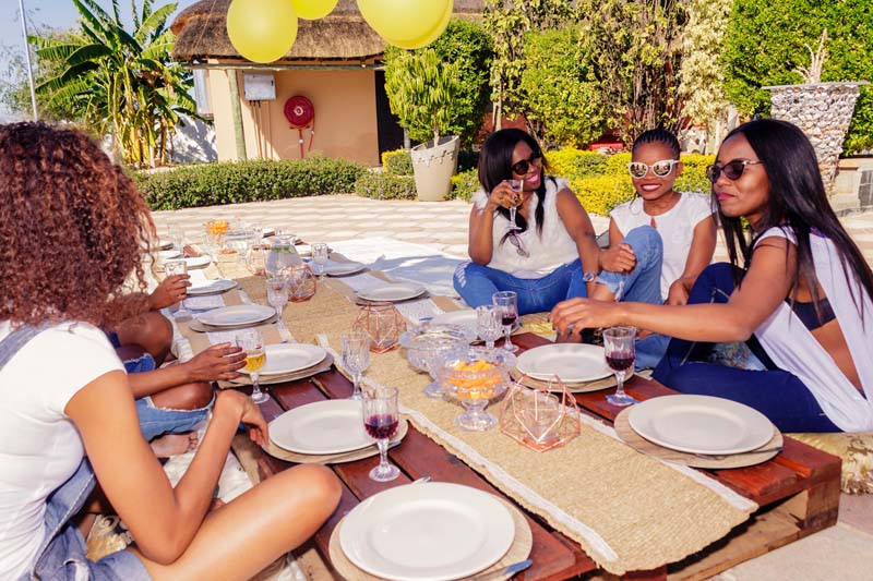 women sitting around table outdoors